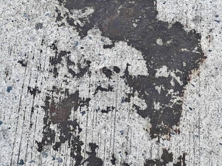 a photography of a dirty sidewalk with a black and white paint.