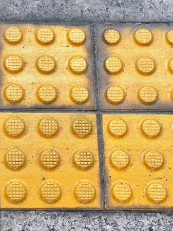 a photography of a yellow and black tile with circles.