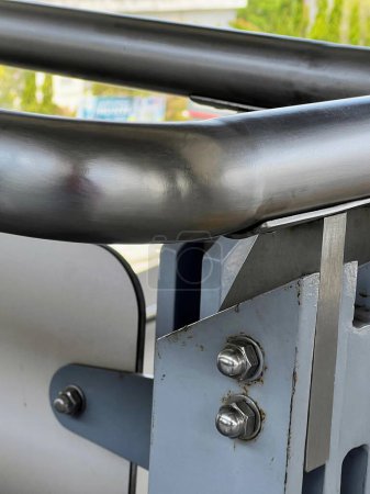 a photography of a metal railing with a metal handle and a metal bar.