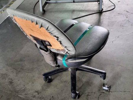 a photography of a chair with a seat that has been torn off.