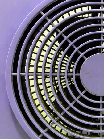 a photography of a white fan with a circular design on it.
