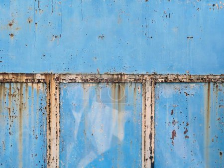 Photo for A photography of a blue wall with rust and a window. - Royalty Free Image