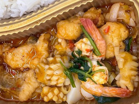 a photography of a container of food with rice and shrimp.