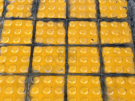 a photography of a yellow brick floor with a lot of yellow bricks.