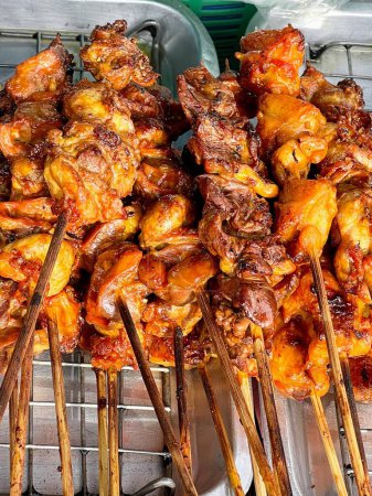 a photography of a bunch of chicken skewers on a grill.