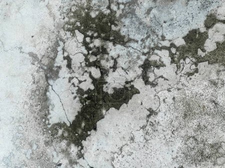 a photography of a dirty wall with a black and white pattern.