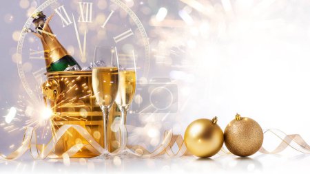 Photo for Happy New Year! A golden bucket with champagne, two glasses and a golden serpentine against the background of a clock face. - Royalty Free Image