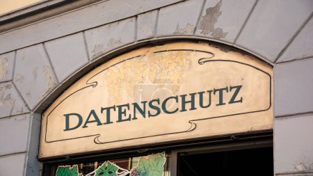 the picture shows a signpost and a sign that points in the direction of data protection in german.