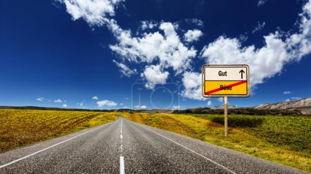Photo for An image with a signpost pointing in two different directions in German. One direction points to good, the other points to evil. - Royalty Free Image