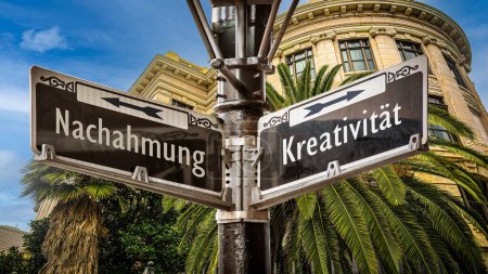 Photo for An image with a signpost pointing in two different directions in German. One direction points to creativity, the other points to imitation. - Royalty Free Image