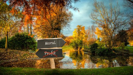 Photo for An image with a signpost pointing in two different directions in German. One direction points to morality, the other points to profit. - Royalty Free Image