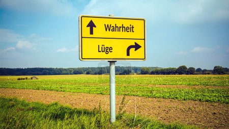 Téléchargez les photos : Une image avec un panneau pointant dans deux directions différentes en allemand. Une direction pointe vers la vérité, l'autre vers les mensonges. - en image libre de droit