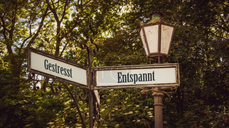Photo for An image with a signpost pointing in two different directions in German. One direction points to Relaxed, the other points to Stressed. - Royalty Free Image