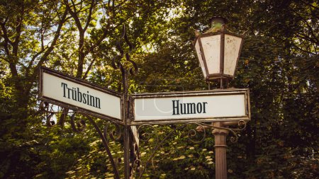 Photo for An image with a signpost pointing in two different directions in German. One direction points to humor, the other points to gloom. - Royalty Free Image