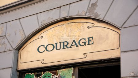 the picture shows a signpost and a sign that points in the direction of courage in german.