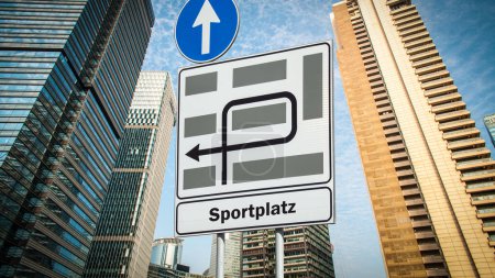An image with a signpost in German pointing in the direction of the sports field.