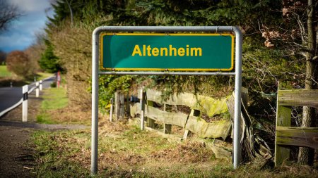 Image with a signpost and sign pointing in the direction of the nursing home in German.