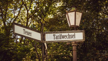 An image with a signpost pointing in two different directions in German. One direction points to Tariff Change, the other points to Expensive.