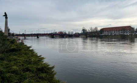 Poland, Gorzow Wielkopolski, 18 February 2024: View of the Warta River, bridge White Barn - a monument of the 18th century, now a branch of the Lubusz Museum. Warta River flood. Flooded shores.