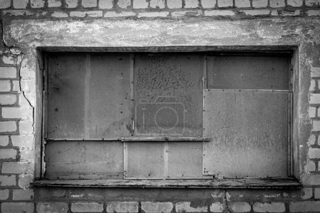 Photo for The windows of an abandoned building are boarded up - Royalty Free Image