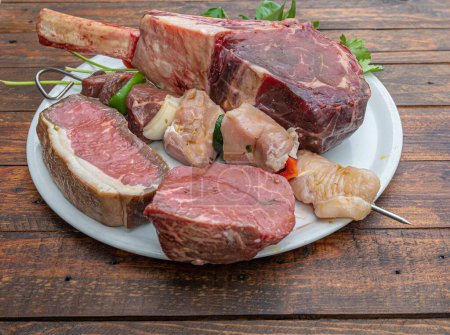Photo for Assorted raw beef cuts ready to be cooked, tomahalk, sirloin, striploin, fillet, skewer - Royalty Free Image
