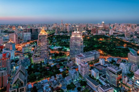 The Lumphini Park and modern buildings in Bangkok City, Thailand
