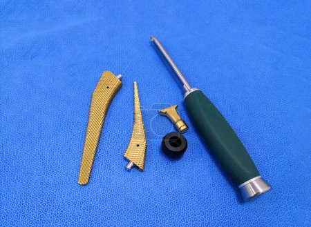 Photo for Closeup Image Of Total Hip Replacement Surgical Instruments In Blue Background - Royalty Free Image
