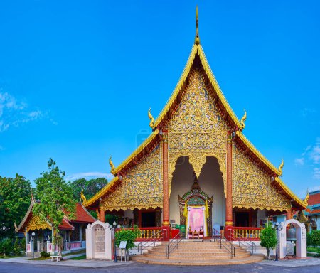 Téléchargez les photos : Les motifs floraux dorés pittoresques sur la façade du viharn dans le temple Wat Chiang Man, Chiang Mai, Thaïlande - en image libre de droit