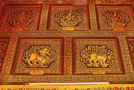 Photo for CHIANG MAI, THAILAND - MAY 3, 2019: The wooden panels with gilt patterns, Singha lions and Devata deities in Vihara of Wat Inthakhin Sadue Muang, on May 3 in Chiang Mai - Royalty Free Image