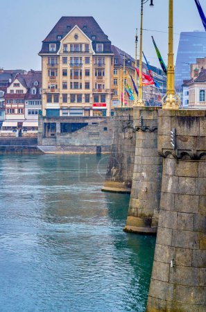 Photo for BASEL, SWITZERLAND - APRIL 1, 2022: The granite Mittlere Brucke bridge and historical building on the bank of Rhine river, on April 1 in Basel, Switzerland - Royalty Free Image