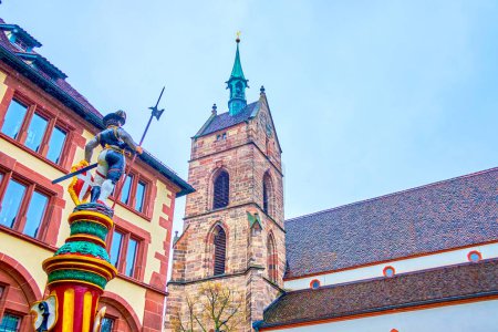 Foto de The colorful sculpture of Sevogelbrunnen fountain and stone bell tower of Martin's Church in Basel, Switzerland - Imagen libre de derechos