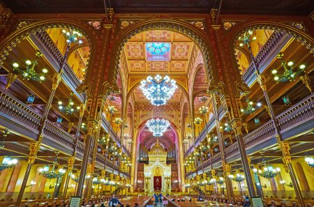 Photo for BUDAPEST, HUNGARY - FEB 22, 2022: Interior of Dohany Street Synagogue with carved wooden furniture, glass chandeliers, moulding and fine patterns on the ceiling, on Feb 22 in Budapest - Royalty Free Image