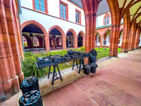 Foto de The art installation of the boxes and bags with vegetables and fruits in small cloister of Basel Minster Cathedral, Switzerland - Imagen libre de derechos