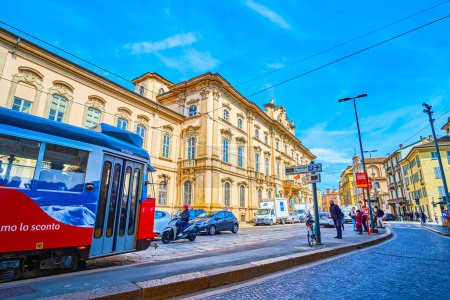 Photo for MILAN, ITALY - APRIL 11, 2022: Urban scene on Corso Magenta street with ridding tram, on April 11 in Milan, Italy - Royalty Free Image