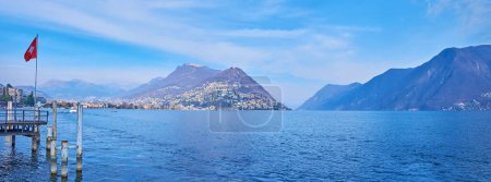 Photo for Panorama of blue surface of Lake Lugano, Monte Bre, Monte Boglia, Monte Sighignola in light haze, Lugano, Ticino, Switzerland - Royalty Free Image