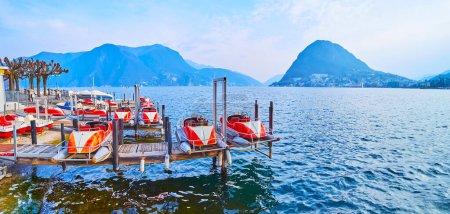 Photo for Panorama of Ceresio with vintage tourist catamarans on pier on Lake Lugano against the Monte San Salvatore, Lugano, Switzerland - Royalty Free Image