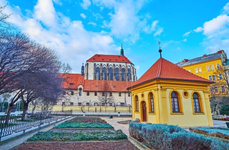 The medieval Our Lady of the Snows Church with herbs garden of the Franciscan Garden with small gazebo in the foreground, Prague, Czechia