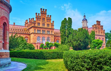 Photo for Beautiful green topiary garden with buildings of Chernivtsi National University in background, Ukraine - Royalty Free Image