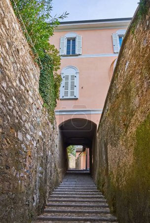 Photo for The narrow ascent, lined with tall stone walls in mountain village of Castagnola, Lugano, Switzerland - Royalty Free Image