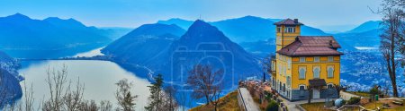 Photo for Panorama from Monte Bre peak with restaurant, big viewing terrace, Monte San Salvatore and Lake Lugano, Ticino, Switzerland - Royalty Free Image