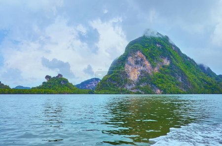 The boat trip to Ao Phang Nga national park with a view on local Islands, covered with tropic greenery and surrounded with mangroves, Thailand