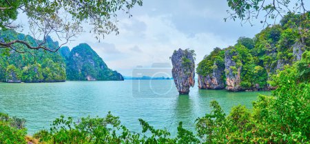 Photo for Panorama of Ao Phang Nga national park with James Bond Island (Khao Phing Kan), karst tower of Ko Ta Pu Island and Ko Raya Ring Island through the jungle, Thailand - Royalty Free Image