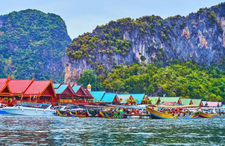 Photo for The colorful wooden houses of Ko Panyi floating village surround the foot of the rock, Ao Phang Nga National Park, Thailand - Royalty Free Image