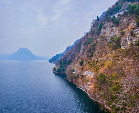 The rocky shore of Lake Luhgano on Olive Tree Trail between Castagnola and Gandria, Lugano, Switzerland