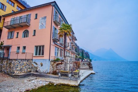 The lakeside building features stunning balconies with magnificent views overlooking Lake Lugano, Gandria, Switzerland,