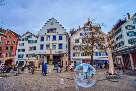 Téléchargez les photos : ZURICH, SUISSE - 3 AVRIL 2022 : Un artiste de rue fait des bulles de savon géantes sur la place Hechtplatz, le 3 avril à Zurich, Suisse - en image libre de droit