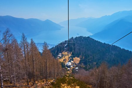 Amazing nature of Lepontine Alps with a view on Lake Maggiore, mountains silhouettes and Cardada from the riding Cimetta Mount chairlift, Ticino, Switzerland