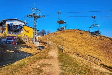 The upper station of Cardada Cimetta chairlift in front od the peak of Mount Cimetta, Ticino, Switzerland