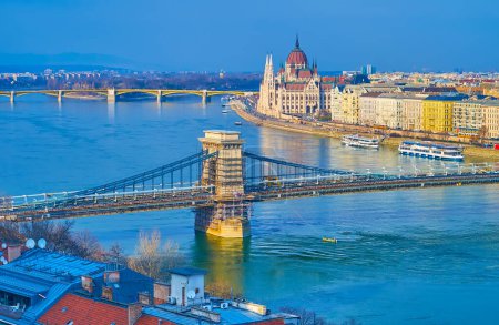 The top view of Danube with Szechenyi Chain and Margaret Bridges and the Neo-Gothic building of Parliament on the Antall Jozsef Quay, Budapest, Hungary