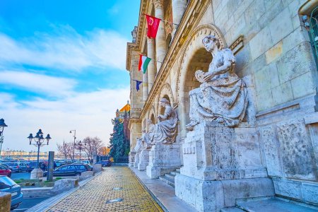 The line of beautiful stone sculptures at the facade of BME University building, Budapest, Hungary